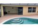 Pool view featuring steps into the water and the sliding doors to the lanai at 1491 E Palomar Dr, Deltona, FL 32738