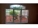 Window with a view of the front yard with red mulch landscaping at 1491 E Palomar Dr, Deltona, FL 32738