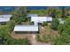 Stunning aerial view of a lakeside property with a detached garage and lush landscaping at 160 Rose Ave, Lake Helen, FL 32744