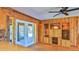 Dining area featuring wood paneled walls, hardwood floors, and outdoor access at 160 Rose Ave, Lake Helen, FL 32744