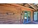 The wood paneled wall leads to a screened-in porch and a set of double doors at 160 Rose Ave, Lake Helen, FL 32744