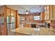 Kitchen with stainless steel appliances, granite countertops, and wood paneled walls at 160 Rose Ave, Lake Helen, FL 32744