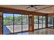 Bright room with lake views from large windows and access to the wooden deck at 160 Rose Ave, Lake Helen, FL 32744