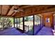 A screened-in porch with wood plank floor and ceiling fan, with an outdoor view at 160 Rose Ave, Lake Helen, FL 32744