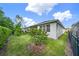 Lush backyard featuring green grass, mature trees, and a black fence, offering privacy at 173 Old Moss Cir, Deland, FL 32724