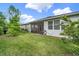 Well-maintained backyard featuring lush green grass, a black fence, and a screened patio at 173 Old Moss Cir, Deland, FL 32724