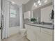 Well-lit bathroom with a shower-tub combo, vanity with granite countertops, and ample storage at 173 Old Moss Cir, Deland, FL 32724