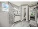 Bright bathroom features a glass shower, marble floors, and stylish fixtures, with a view into the bedroom at 173 Old Moss Cir, Deland, FL 32724