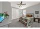 Bedroom features a comfortable bed with a quilt, a ceiling fan, and soft lighting for a cozy retreat at 173 Old Moss Cir, Deland, FL 32724
