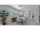 Modern dining area with stylish table and chairs, open to the kitchen, and bathed in natural light at 173 Old Moss Cir, Deland, FL 32724