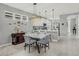 Dining room with modern table and chairs, complemented by stylish light fixtures and a view into the kitchen at 173 Old Moss Cir, Deland, FL 32724