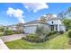 Beautiful single-Gathering home featuring a well-maintained lawn, a paver driveway, and an attached two-car garage at 173 Old Moss Cir, Deland, FL 32724