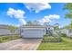 Charming single Gathering home featuring a two-car garage, landscaped front yard, and brick driveway at 173 Old Moss Cir, Deland, FL 32724