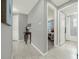 Hallway with wood-look tile flooring leads to a bathroom and bedroom, creating a cohesive and flowing living space at 173 Old Moss Cir, Deland, FL 32724