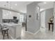 Bright kitchen with white cabinets, a breakfast bar, pendant lighting, and modern stainless-steel appliances at 173 Old Moss Cir, Deland, FL 32724