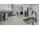 Bright kitchen featuring white cabinets, stainless steel appliances, and a mosaic tile backsplash at 173 Old Moss Cir, Deland, FL 32724