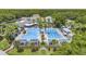 Beautiful aerial view of pools surrounded by palm trees, lounging areas, and lush landscaping at 173 Old Moss Cir, Deland, FL 32724
