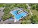 Aerial view of a sparkling pool area with multiple pools, palm trees, and lounge chairs at 173 Old Moss Cir, Deland, FL 32724