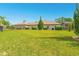 Large backyard with a well-manicured lawn, privacy fence, and partial view of a covered outdoor space at 1855 Cattle Creek Ln, Port Orange, FL 32128