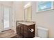 Bathroom featuring a granite-topped vanity with storage, and a convenient toilet at 1855 Cattle Creek Ln, Port Orange, FL 32128