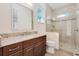 Well-lit bathroom showcases a granite vanity and a tiled walk-in shower with glass door at 1855 Cattle Creek Ln, Port Orange, FL 32128
