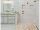 Modern bathroom with double shower heads and decorative floor, adjacent to a vanity with granite countertop at 1855 Cattle Creek Ln, Port Orange, FL 32128