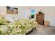 Comfortable bedroom with a large bed, dresser, and natural light from the window at 1855 Cattle Creek Ln, Port Orange, FL 32128
