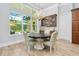 Cozy dining room featuring a stylish table, chairs, a built-in bar and exterior views at 1855 Cattle Creek Ln, Port Orange, FL 32128
