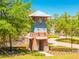 Charming gated community entrance featuring brick and siding accents with manicured landscaping at 1855 Cattle Creek Ln, Port Orange, FL 32128