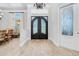 Inviting foyer showcases a decorative wrought iron double door, tile flooring, and elegant chandelier at 1855 Cattle Creek Ln, Port Orange, FL 32128