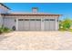 Spacious three-car garage with decorative windows and a brick-paved driveway, offering ample parking and curb appeal at 1855 Cattle Creek Ln, Port Orange, FL 32128