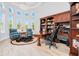 Spacious office area featuring a large bookcase, desk, seating and bright lighting at 1855 Cattle Creek Ln, Port Orange, FL 32128