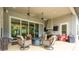 Inviting outdoor living space with a built-in grill, lounge area, and ceiling fans at 1855 Cattle Creek Ln, Port Orange, FL 32128