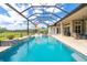 Resort-style pool with a screened-in enclosure, outdoor seating, and lush landscaping at 1855 Cattle Creek Ln, Port Orange, FL 32128