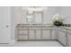 Bathroom vanity featuring granite countertops, custom cabinetry, and a large mirror at 1855 Cattle Creek Ln, Port Orange, FL 32128
