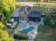 Aerial image showcasing a home with a pool, deck, pergola, patio, and lush green landscape at 1899 W Beresford Ave, Deland, FL 32720