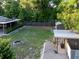 Aerial view of a backyard with an outdoor shower, shed, and metal covered parking area at 1899 W Beresford Ave, Deland, FL 32720
