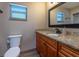 Cozy bathroom showcasing granite counters, cherry wood cabinets, and neutral wall paint at 1899 W Beresford Ave, Deland, FL 32720