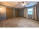Spacious bedroom with two closets, neutral carpet, ceiling fan, and grey painted walls at 1899 W Beresford Ave, Deland, FL 32720