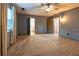 Large bedroom with new neutral carpet, ceiling fan, and light grey painted walls at 1899 W Beresford Ave, Deland, FL 32720