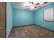 Bright bedroom with teal painted walls, neutral carpet, and large window with blinds at 1899 W Beresford Ave, Deland, FL 32720