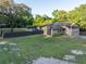 Charming two-story home featuring solar panels, a lush green lawn, and a rustic fence at 1899 W Beresford Ave, Deland, FL 32720