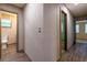 Neutral hallway featuring new laminate flooring, doors leading to bedrooms and bathrooms at 1899 W Beresford Ave, Deland, FL 32720