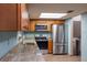 Charming kitchen featuring granite countertops, stainless steel appliances, and wood cabinets at 1899 W Beresford Ave, Deland, FL 32720