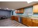 Bright kitchen features wood cabinetry, stainless steel appliances and vinyl flooring at 1899 W Beresford Ave, Deland, FL 32720