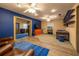 Open-concept living space boasting a colorful accent wall, wood flooring, and comfortable seating at 1899 W Beresford Ave, Deland, FL 32720