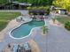 Aerial view of a kidney-shaped pool with a swim-up bar and lounge chairs at 1899 W Beresford Ave, Deland, FL 32720