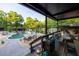 A luxurious pool with lounge chairs and mature trees creates a backyard oasis for relaxation and enjoyment at 1899 W Beresford Ave, Deland, FL 32720