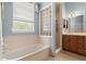 Well-lit bathroom with a soaking tub and separate shower at 2030 Waterford Estates Dr, New Smyrna Beach, FL 32168