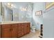 Bathroom with a large mirror, double vanity, and toilet at 2030 Waterford Estates Dr, New Smyrna Beach, FL 32168